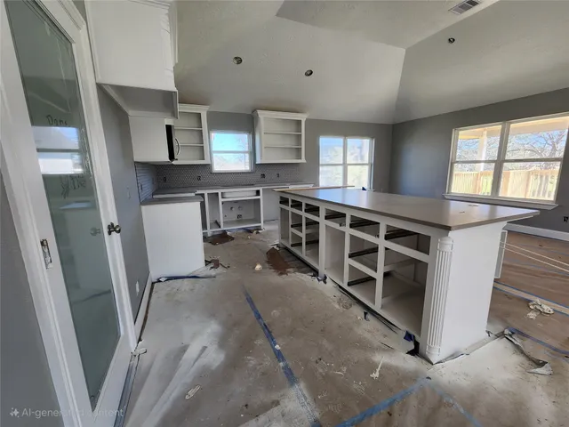 a view of a kitchen with fridge and wooden floor