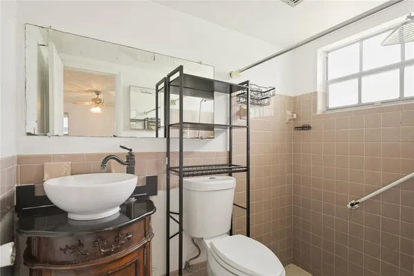 a bathroom with a sink toilet and shower