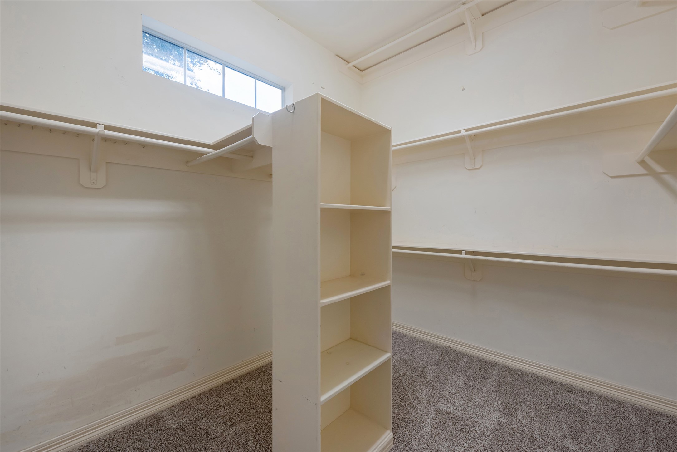 15306 Beecham Drive Houston, TX 77068 - Photo 20 of 48 Huge walk in closet has storage and multiple racks for hanging clothes.