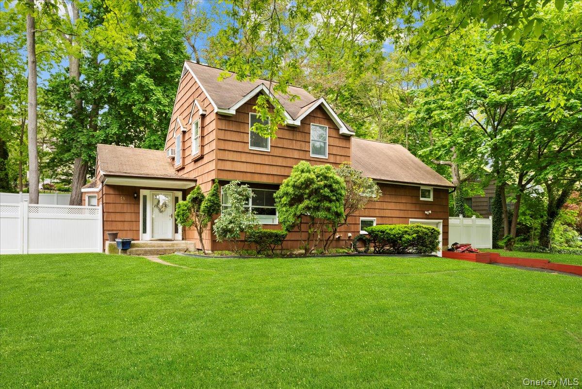 18 Nursery Road Melville, NY 11747 - Photo 2 of 17 a front view of a house with a garden and trees