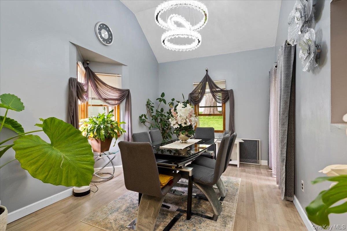 18 Nursery Road Melville, NY 11747 - Photo 3 of 17 a view of a dining room with furniture and a potted plant