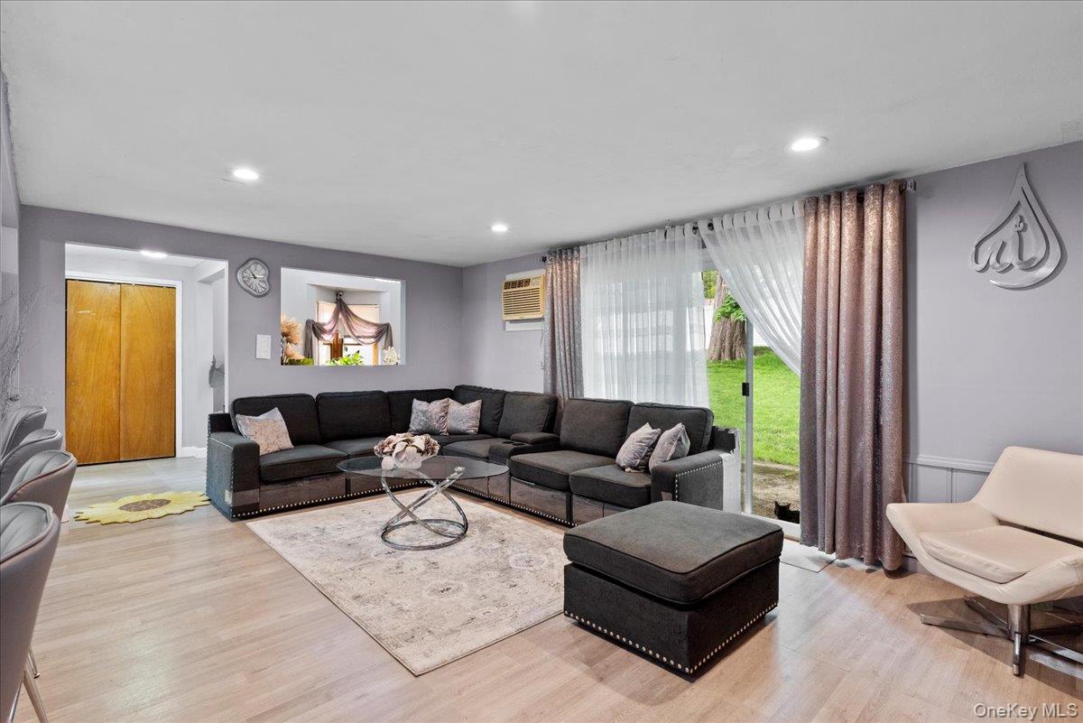 18 Nursery Road Melville, NY 11747 - Photo 5 of 17 a living room with furniture and a wooden floor