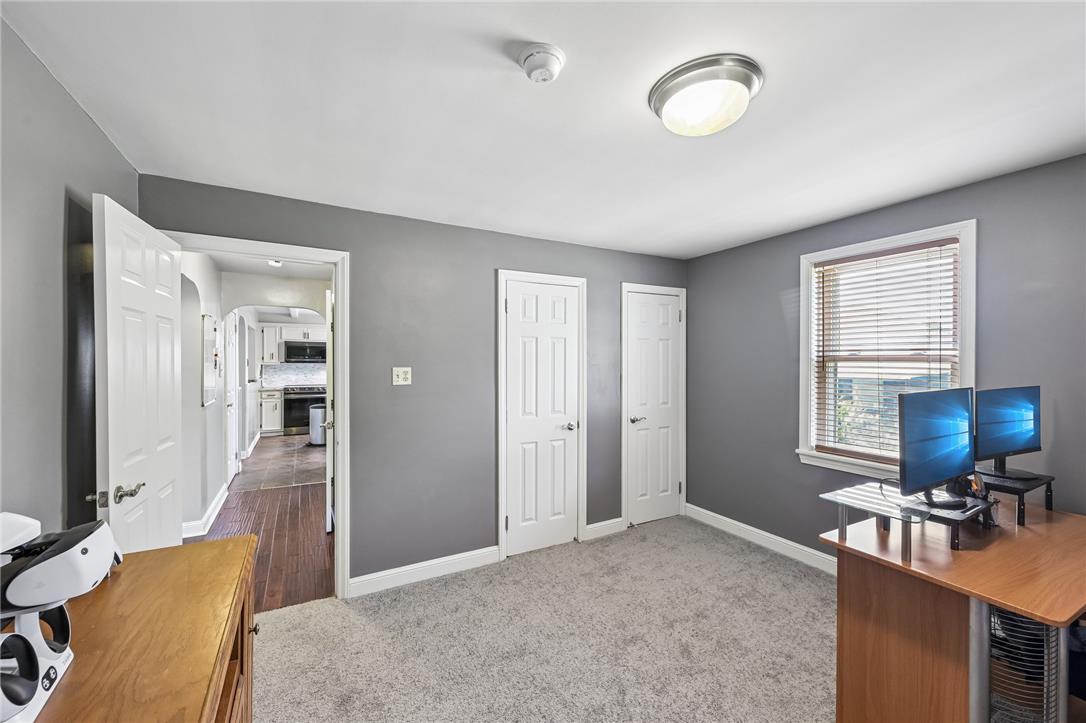 4065 Airport Road Allentown, PA 18109 - Photo 14 of 28 A well-lit room with warm gray walls and plush carpeting, perfect for quiet contemplation or productive work.