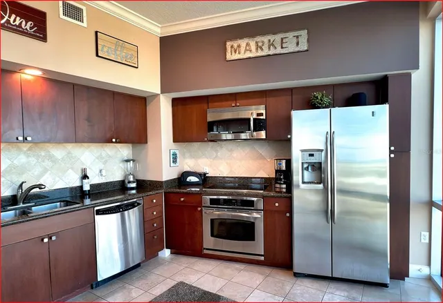 a kitchen with a refrigerator sink and stove