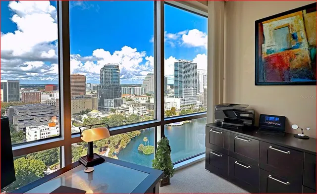 a kitchen with a large window and a view of living room
