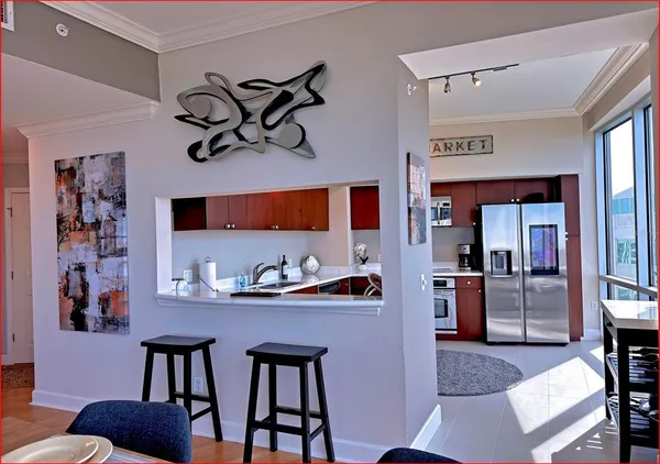 a kitchen with stainless steel appliances granite countertop a refrigerator and stove