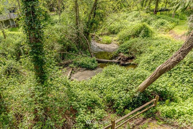 a view of a balcony with wooden fence and floor