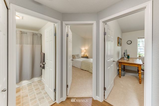 a bathroom with a sink a toilet a mirror and shower curtain
