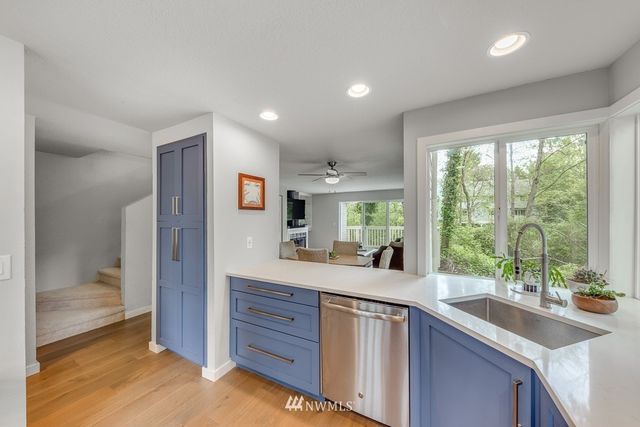 a kitchen with sink and view living room