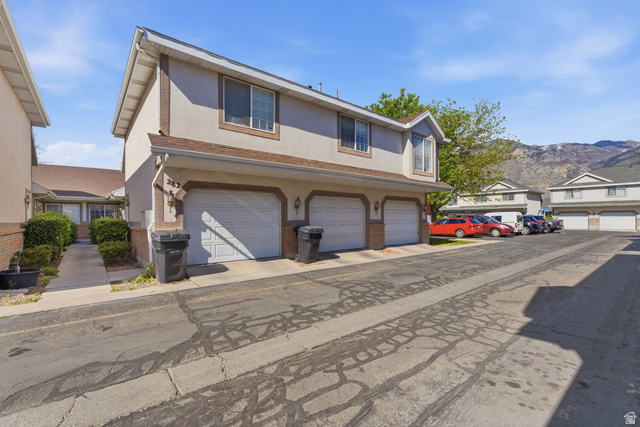 282 West 960 South, Unit C Provo, UT 84601 - Photo 31 of 33 Traditional-style house with stucco siding, a mountain view, a residential view, and brick siding