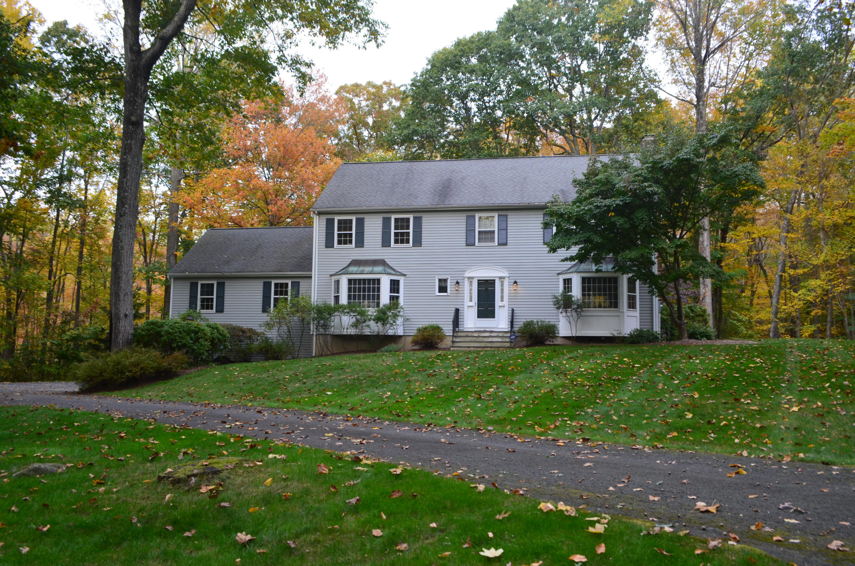 30 Mayapple Road Wilton, CT 06897 - Photo 23 of 24 a view of a yard in front of a house with plants and large tree
