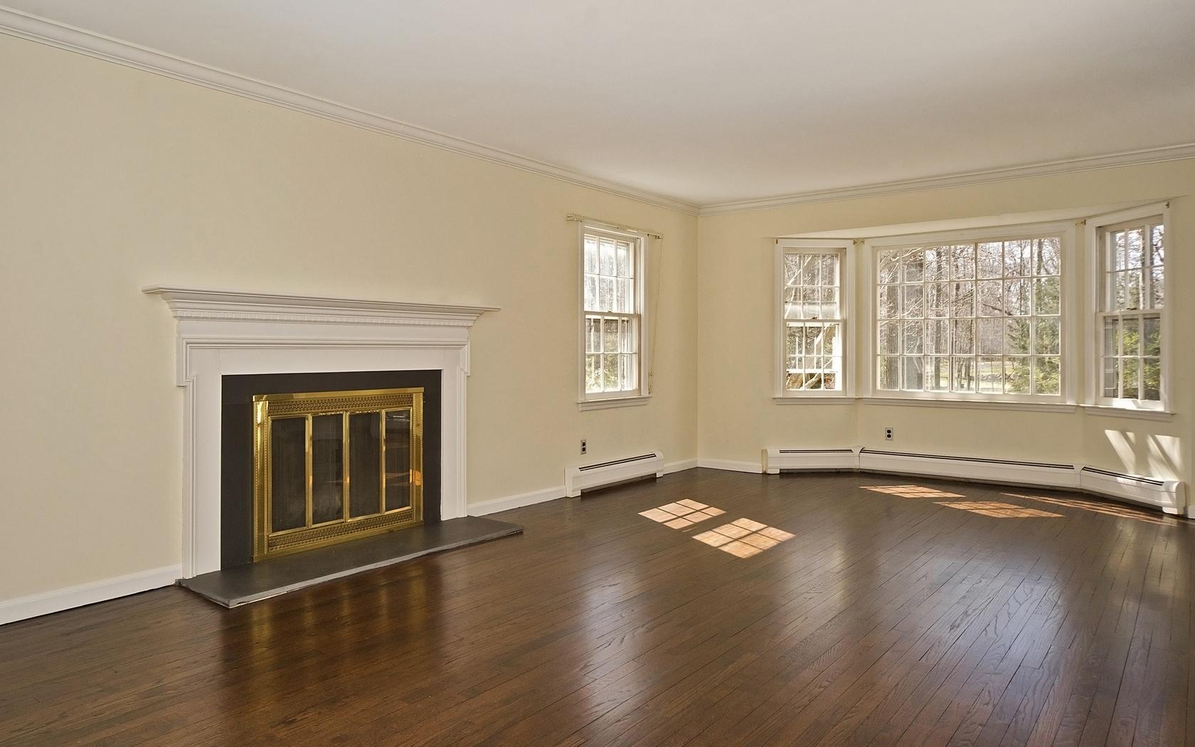 30 Mayapple Road Wilton, CT 06897 - Photo 3 of 24 an empty room with wooden floor and windows