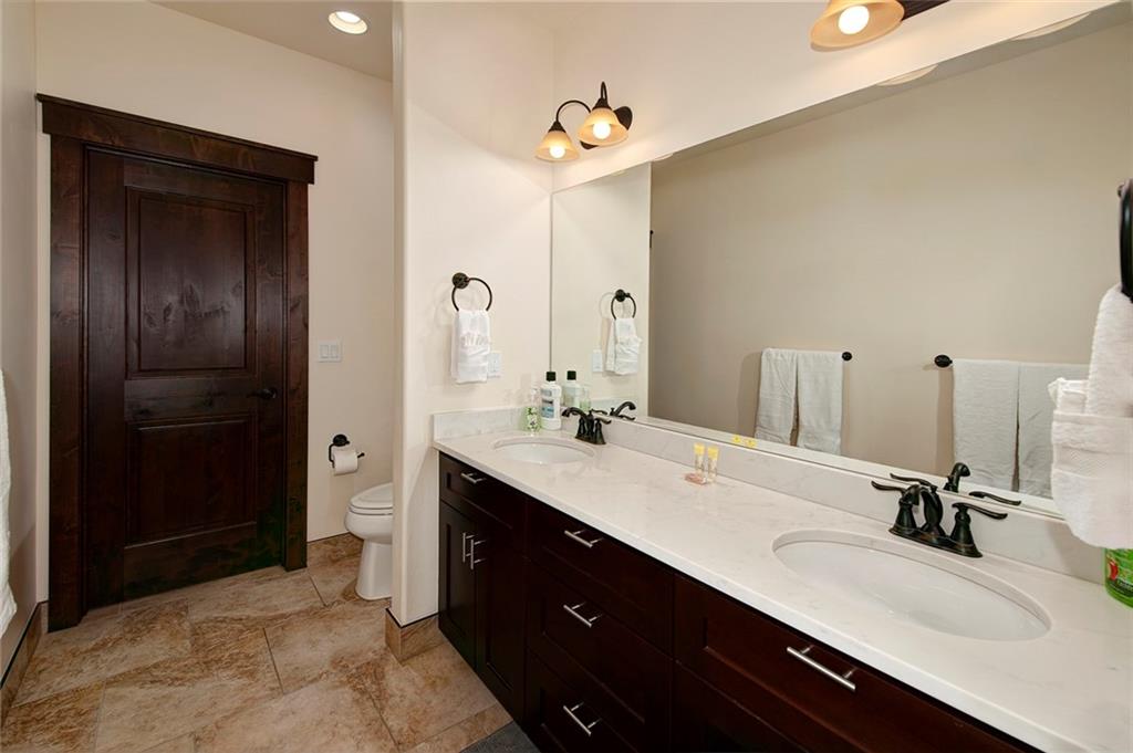 767 Independence Road, Unit 3A Keystone, CO 80435 - Photo 13 of 35 a bathroom with a double vanity sink a and mirror