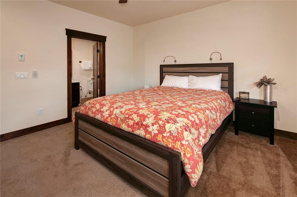 767 Independence Road, Unit 3A Keystone, CO 80435 - Photo 17 of 35 a bed sitting in a bedroom next to a bathroom with mirror