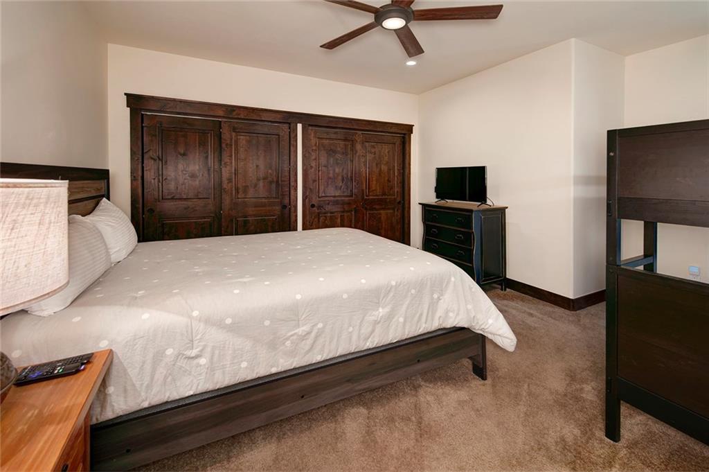767 Independence Road, Unit 3A Keystone, CO 80435 - Photo 21 of 35 a bedroom with a bed and a flat tv screen on dresser