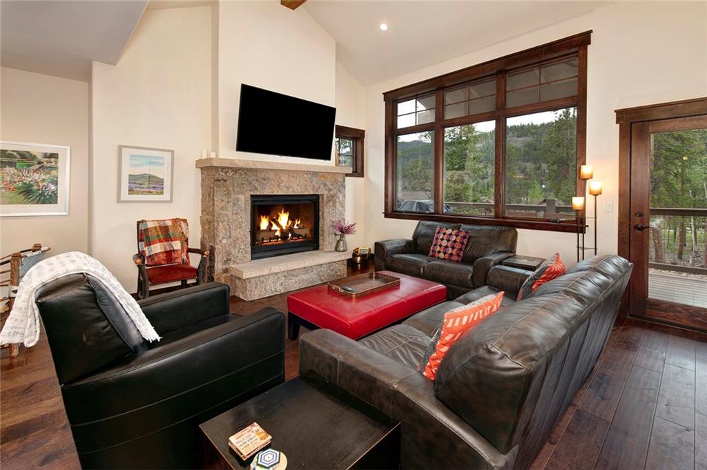 767 Independence Road, Unit 3A Keystone, CO 80435 - Photo 4 of 35 a living room with furniture a flat screen tv and a fireplace