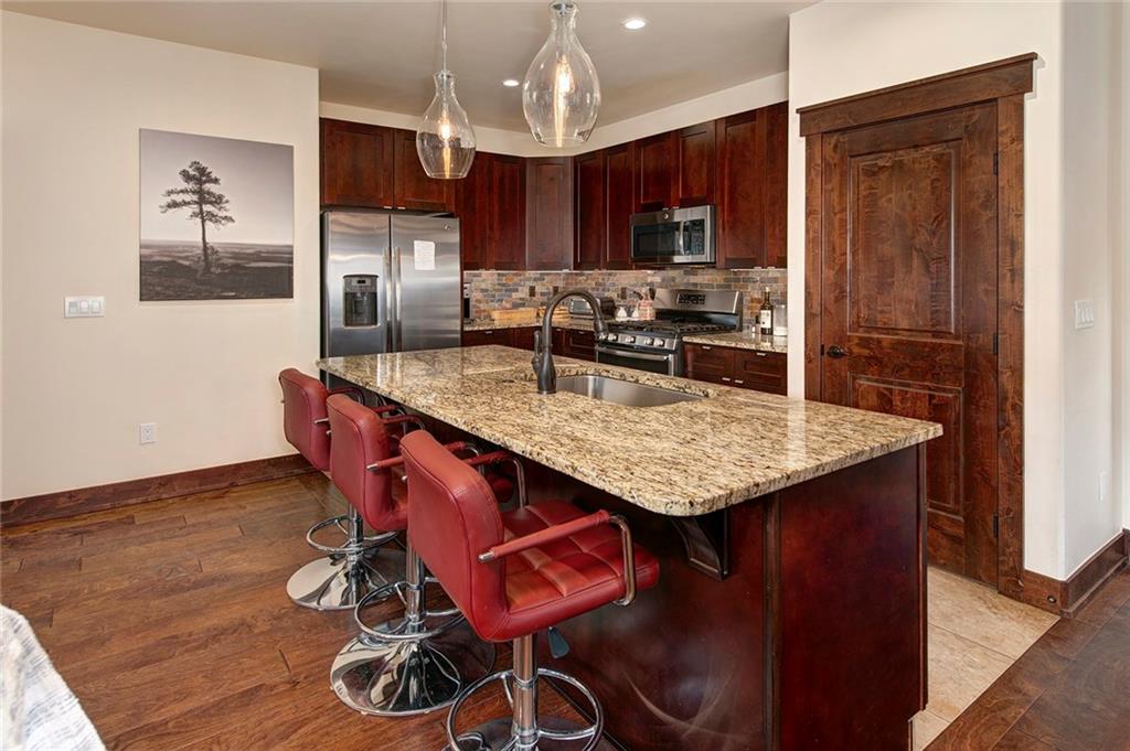 767 Independence Road, Unit 3A Keystone, CO 80435 - Photo 9 of 35 a kitchen with granite countertop kitchen island stainless steel appliances cabinets a sink and a counter top space