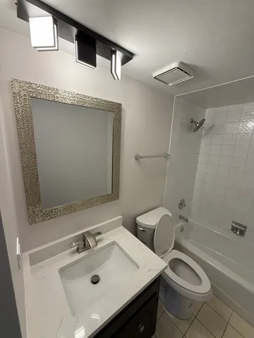 a bathroom with a toilet and a mirror