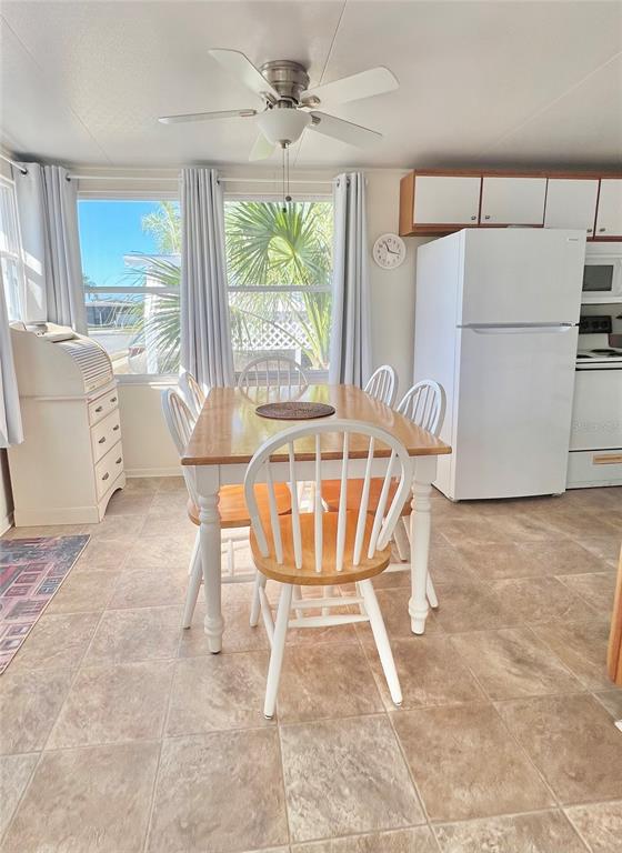 1100 South Belcher Road, Unit 23 Largo, FL 33771 - Photo 16 of 87 a view of a dining room with furniture a chandelier and wooden floor