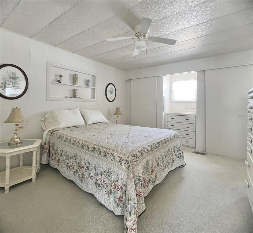 1100 South Belcher Road, Unit 23 Largo, FL 33771 - Photo 31 of 87 a spacious bedroom with a bed and a chandelier