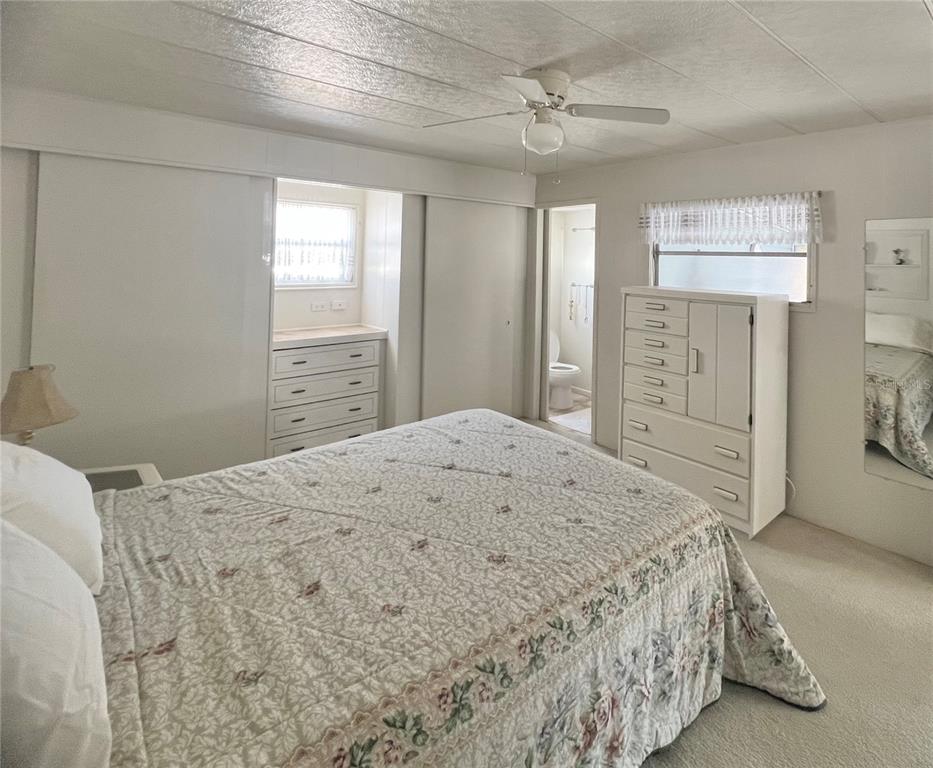 1100 South Belcher Road, Unit 23 Largo, FL 33771 - Photo 32 of 87 a bedroom with a large bed and a chandelier