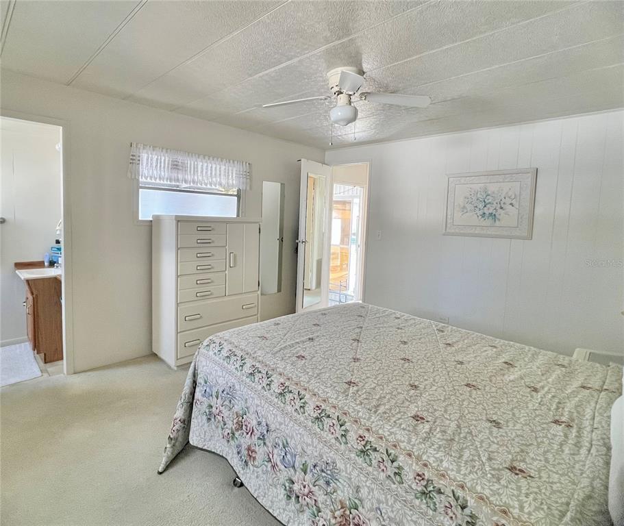 1100 South Belcher Road, Unit 23 Largo, FL 33771 - Photo 33 of 87 a bedroom with a large bed and a chandelier