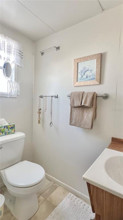 1100 South Belcher Road, Unit 23 Largo, FL 33771 - Photo 34 of 87 a white toilet sitting next to a bathroom sink and vanity