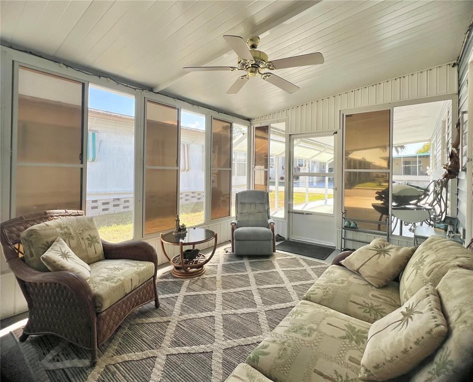 1100 South Belcher Road, Unit 23 Largo, FL 33771 - Photo 39 of 87 a living room with furniture and floor to ceiling windows