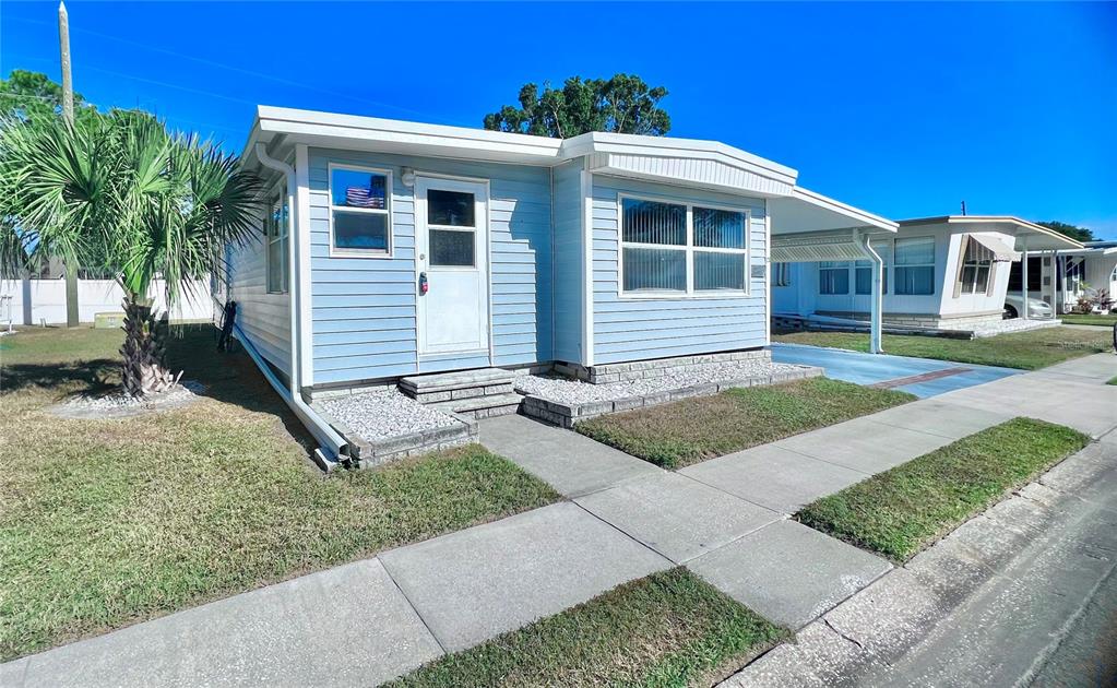 1100 South Belcher Road, Unit 23 Largo, FL 33771 - Photo 4 of 87 a front view of a house with garden