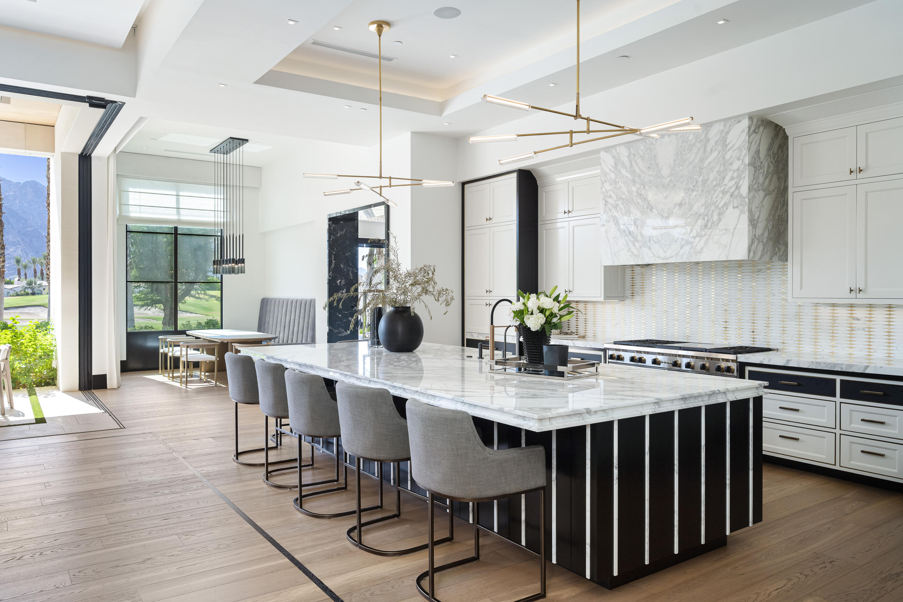 53747 Via Strada La Quinta, CA 92253 - Photo 15 of 59 a kitchen with a stove a table and chairs in it