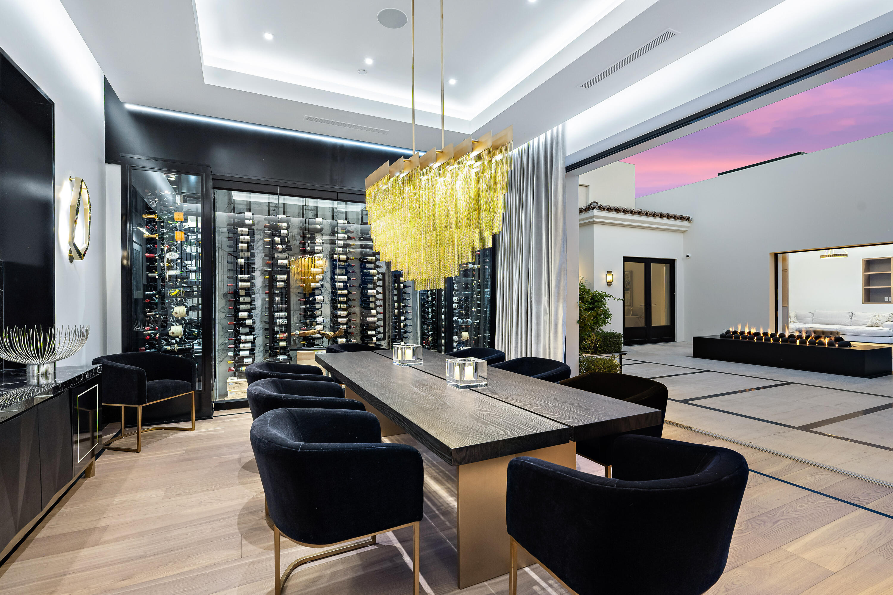 53747 Via Strada La Quinta, CA 92253 - Photo 24 of 59 a living room with couches a dining table and chairs with wooden floor