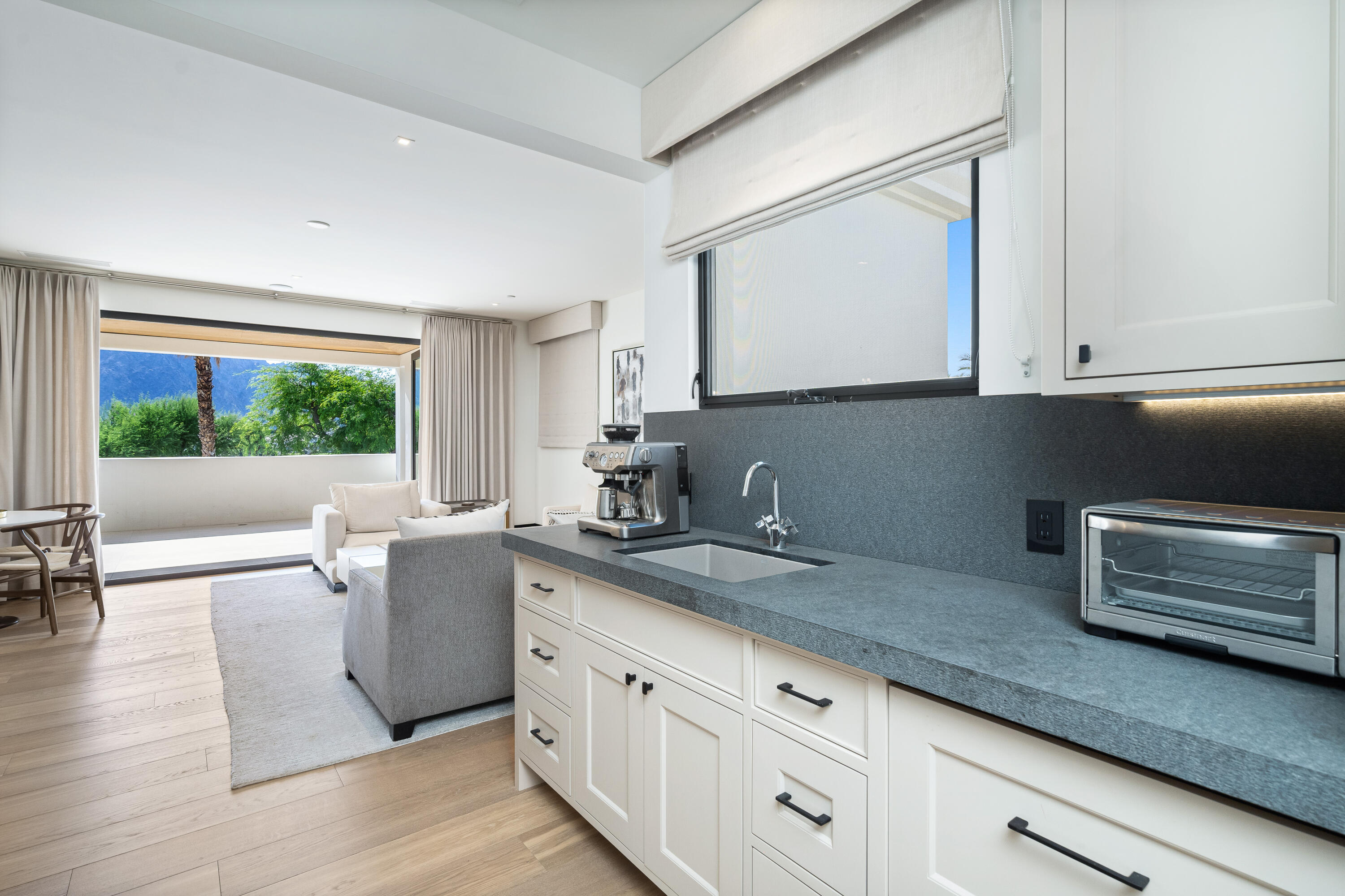53747 Via Strada La Quinta, CA 92253 - Photo 37 of 59 a kitchen with granite countertop a sink and white cabinets