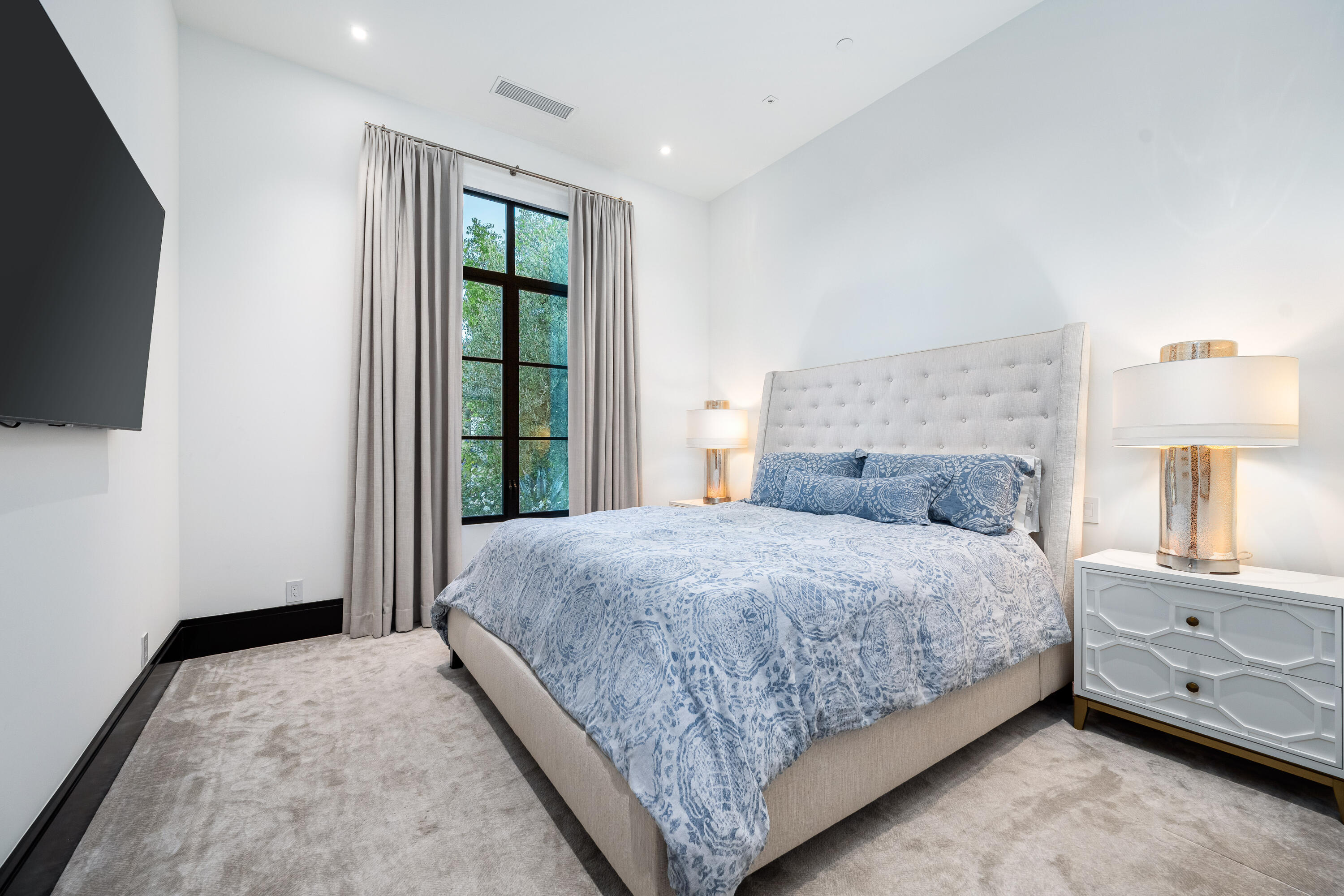 53747 Via Strada La Quinta, CA 92253 - Photo 44 of 59 a bedroom with a bed and a flat tv screen on the dresser
