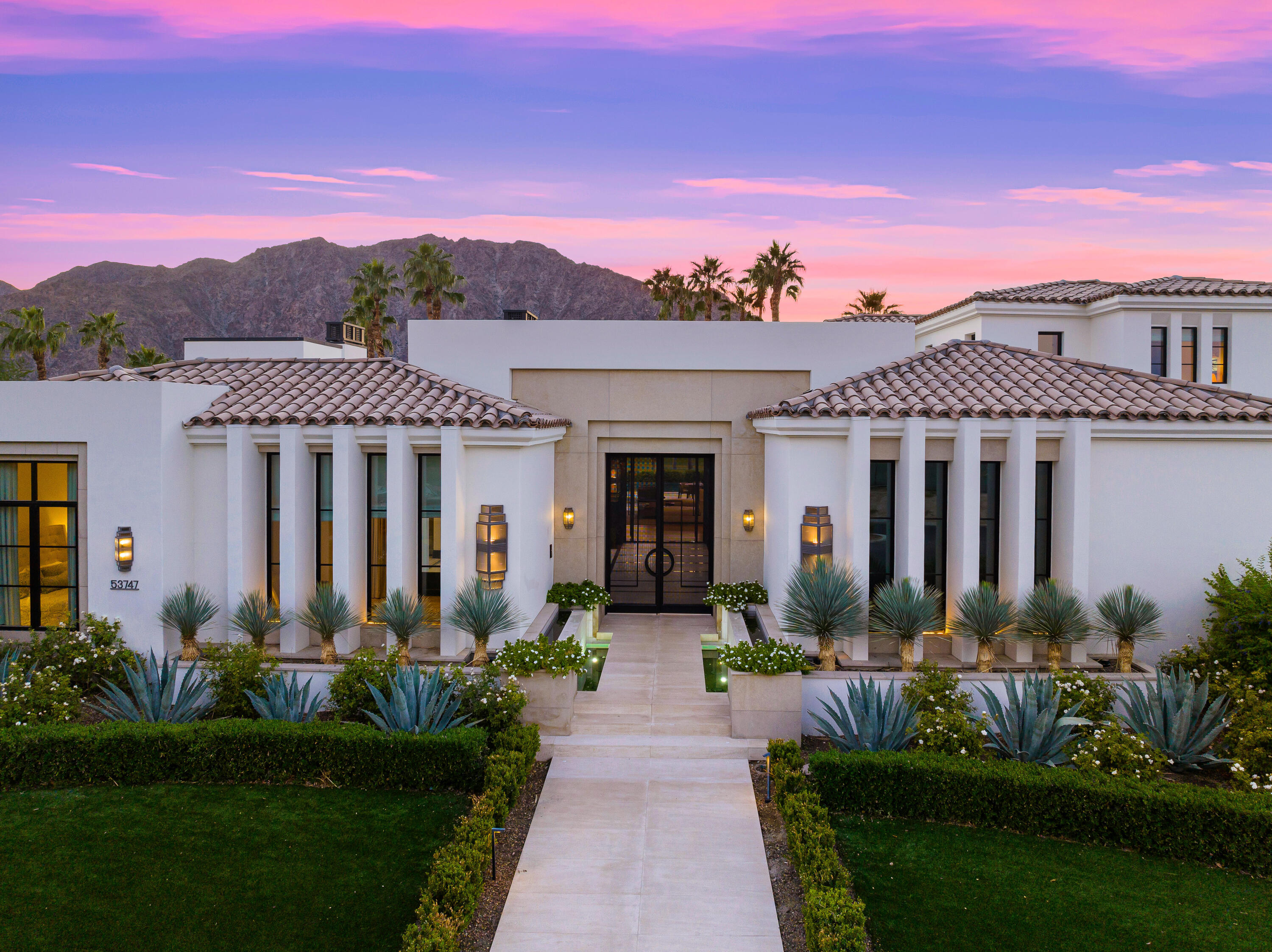53747 Via Strada La Quinta, CA 92253 - Photo 5 of 59 a front view of a house with a yard and potted plants