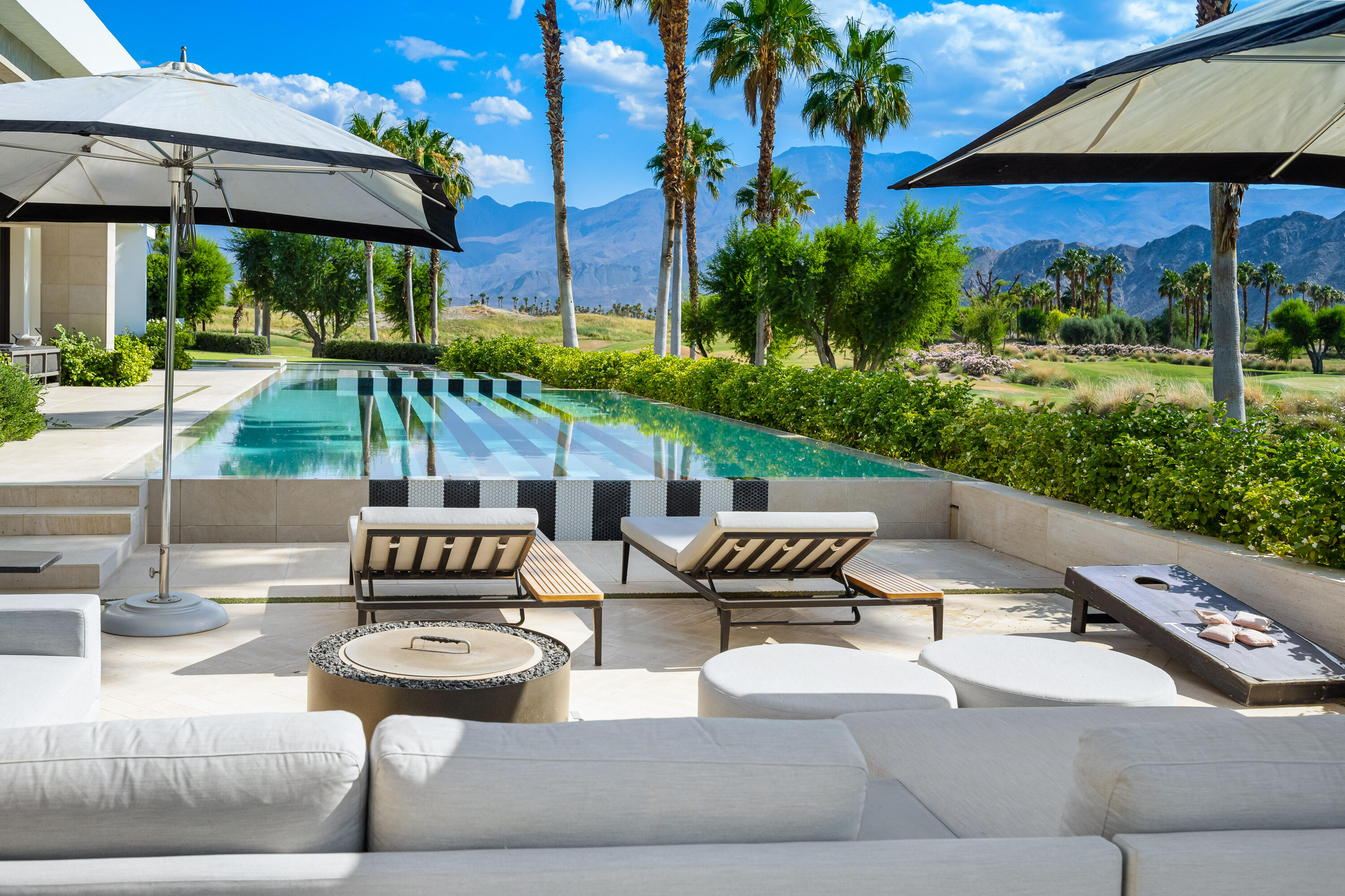 53747 Via Strada La Quinta, CA 92253 - Photo 53 of 59 a view of a patio with couches table and chairs under an umbrella