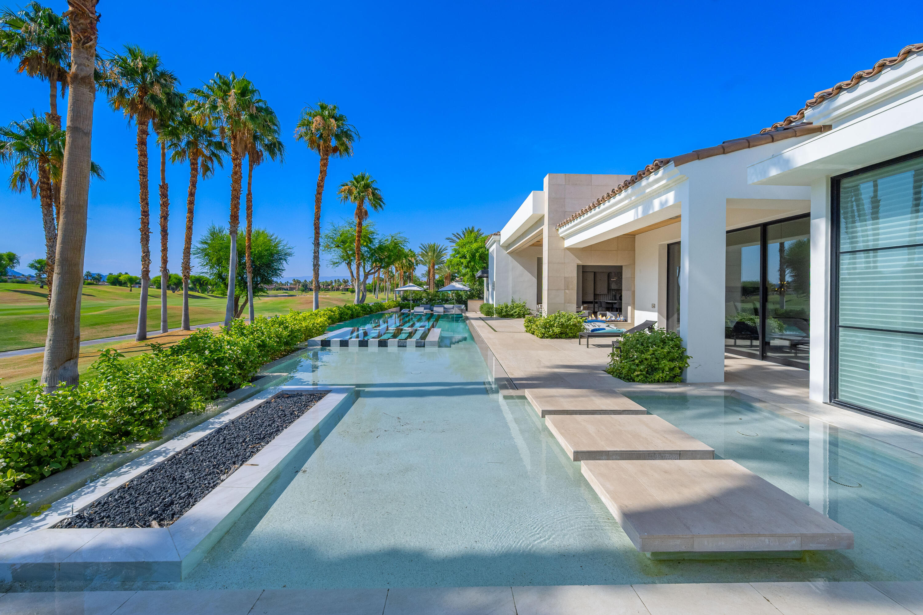 53747 Via Strada La Quinta, CA 92253 - Photo 54 of 59 a front view of a house with a garden and yard