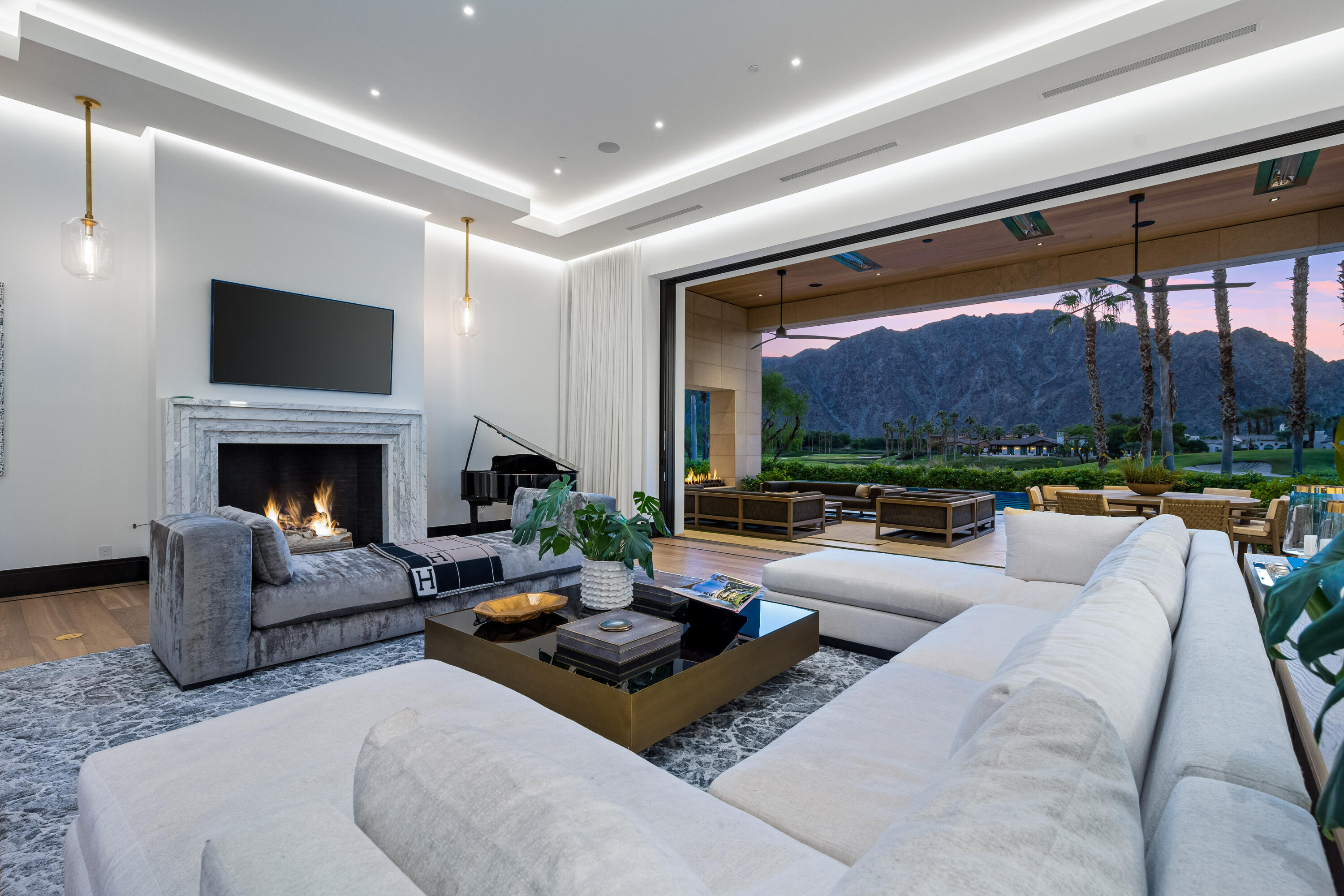 53747 Via Strada La Quinta, CA 92253 - Photo 10 of 59 a living room with furniture fireplace and a large window