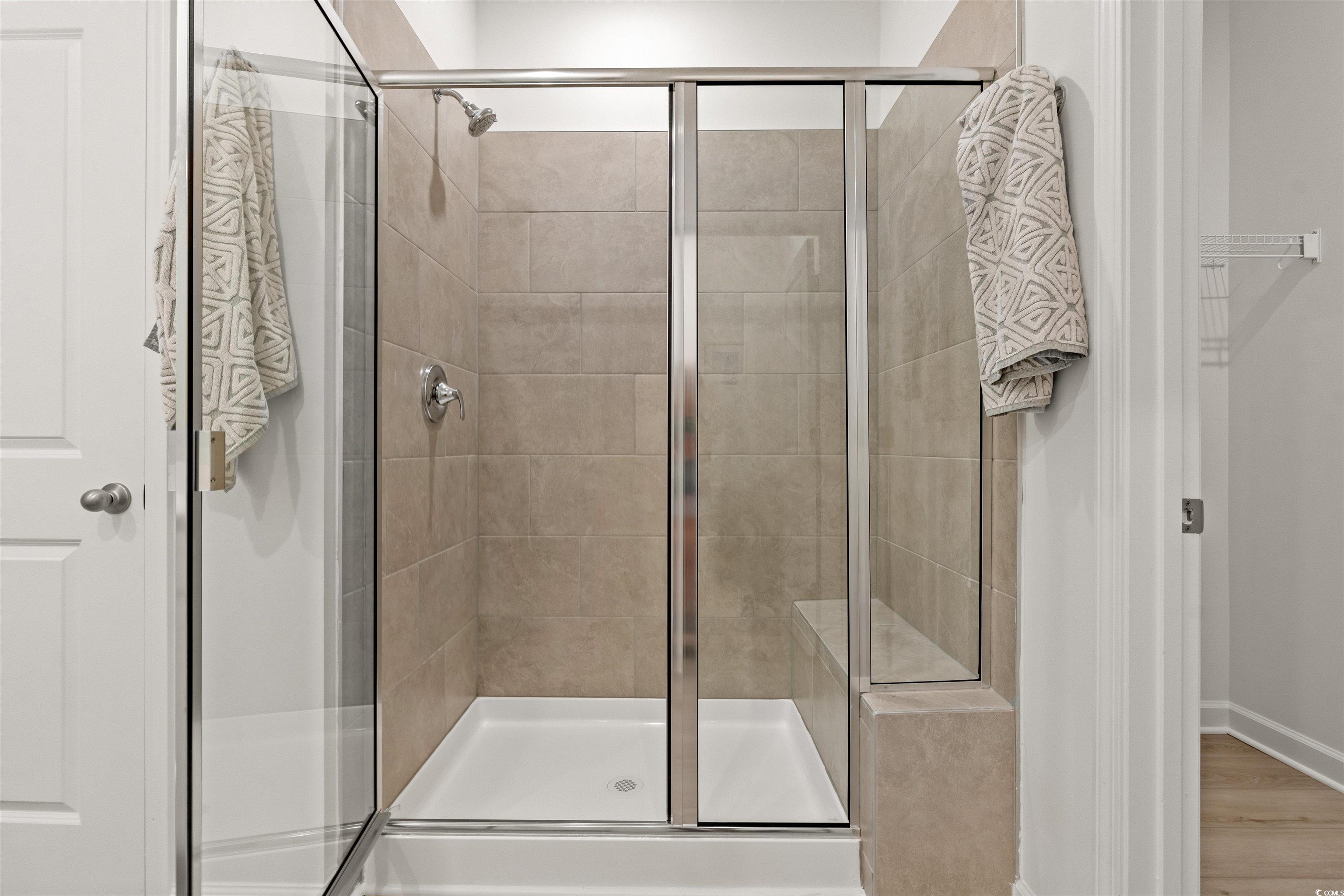 1546 Regal Fern Way Longs, SC 29568 - Photo 15 of 34 Bathroom with a shower stall, a spacious closet, and wood finished floors