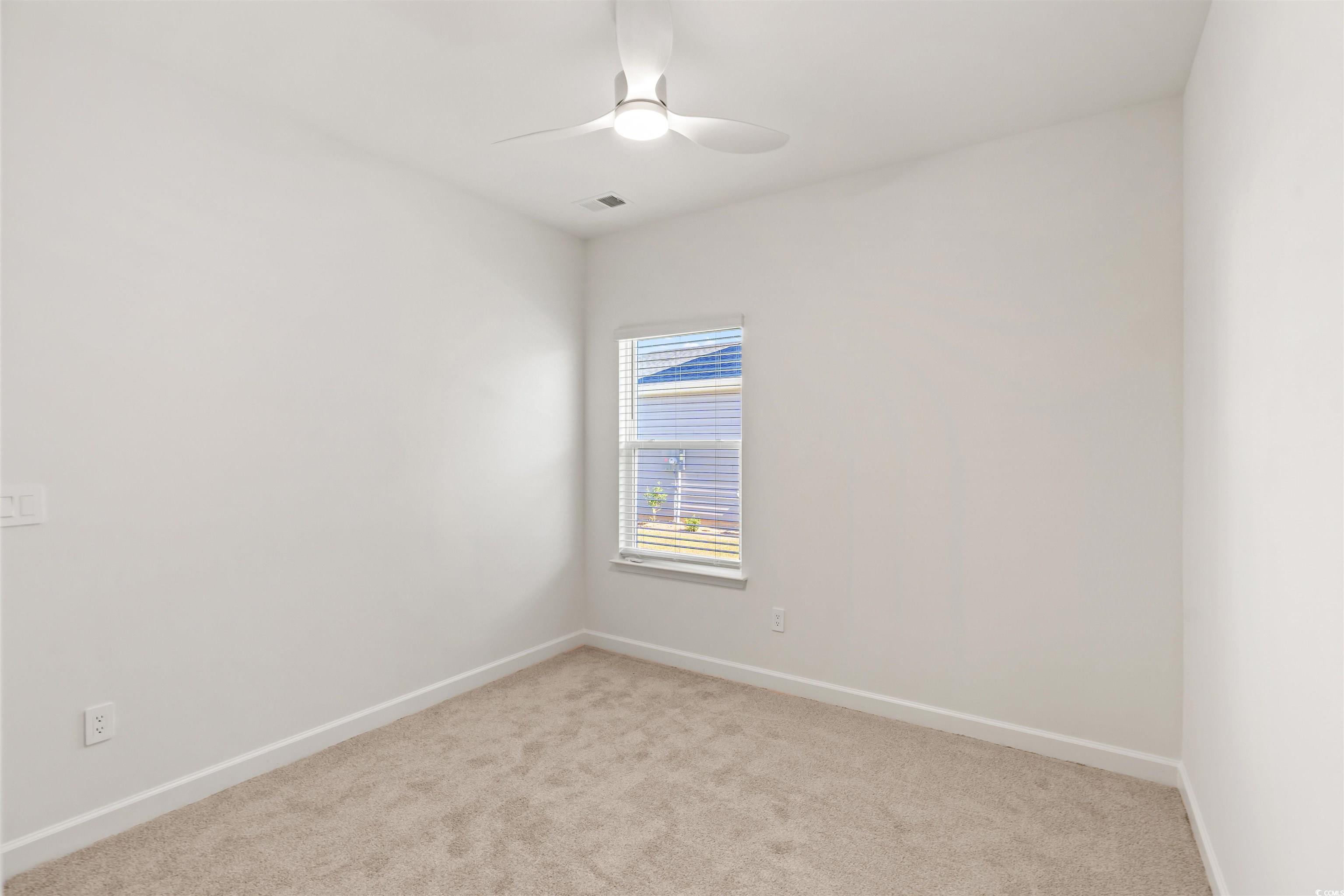 1546 Regal Fern Way Longs, SC 29568 - Photo 22 of 34 Empty room featuring light carpet and ceiling fan