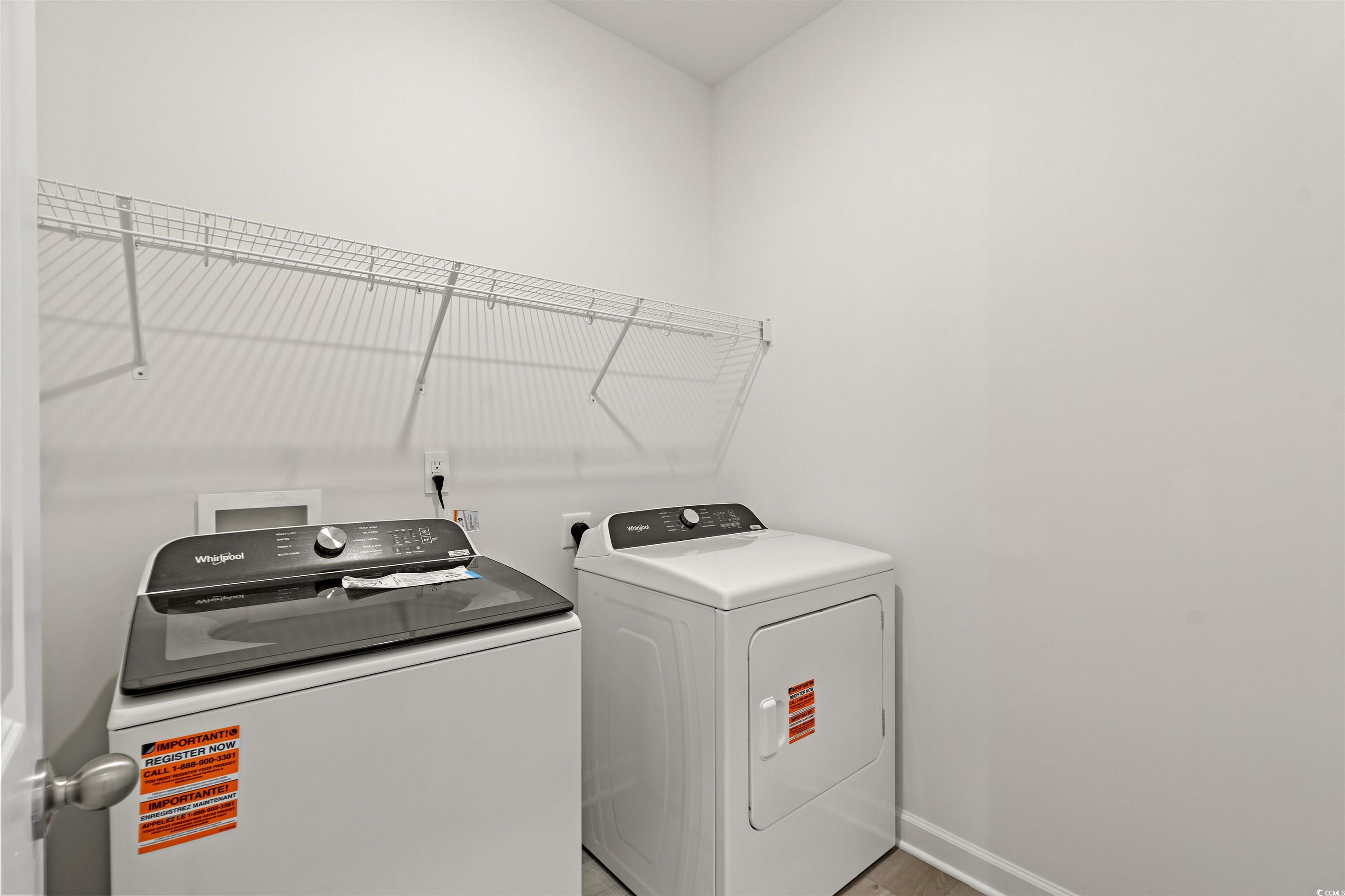 1546 Regal Fern Way Longs, SC 29568 - Photo 24 of 34 Laundry area featuring washing machine and clothes dryer and wood finished floors