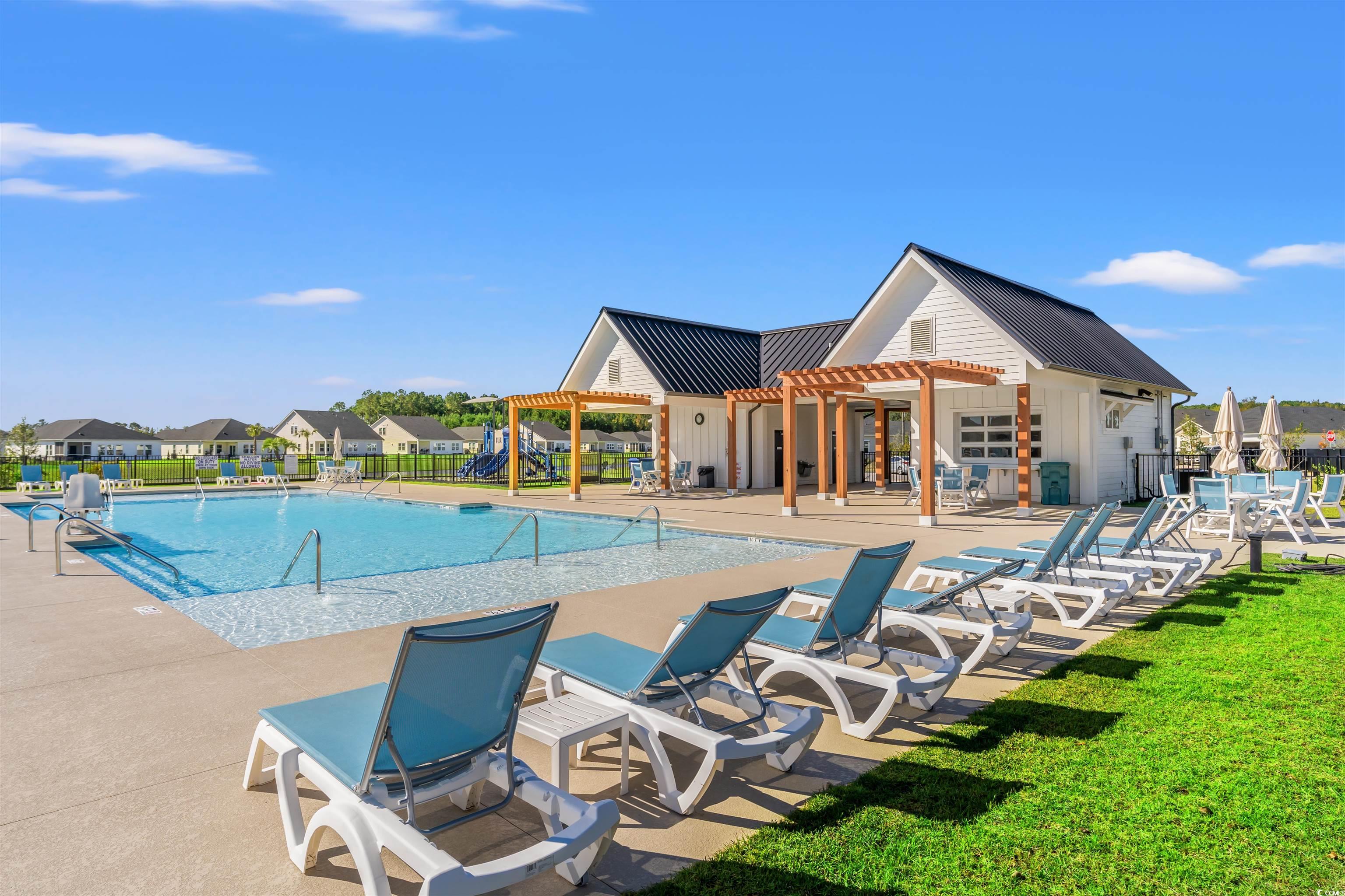1546 Regal Fern Way Longs, SC 29568 - Photo 28 of 34 Community pool featuring a pergola, a patio, and a residential view