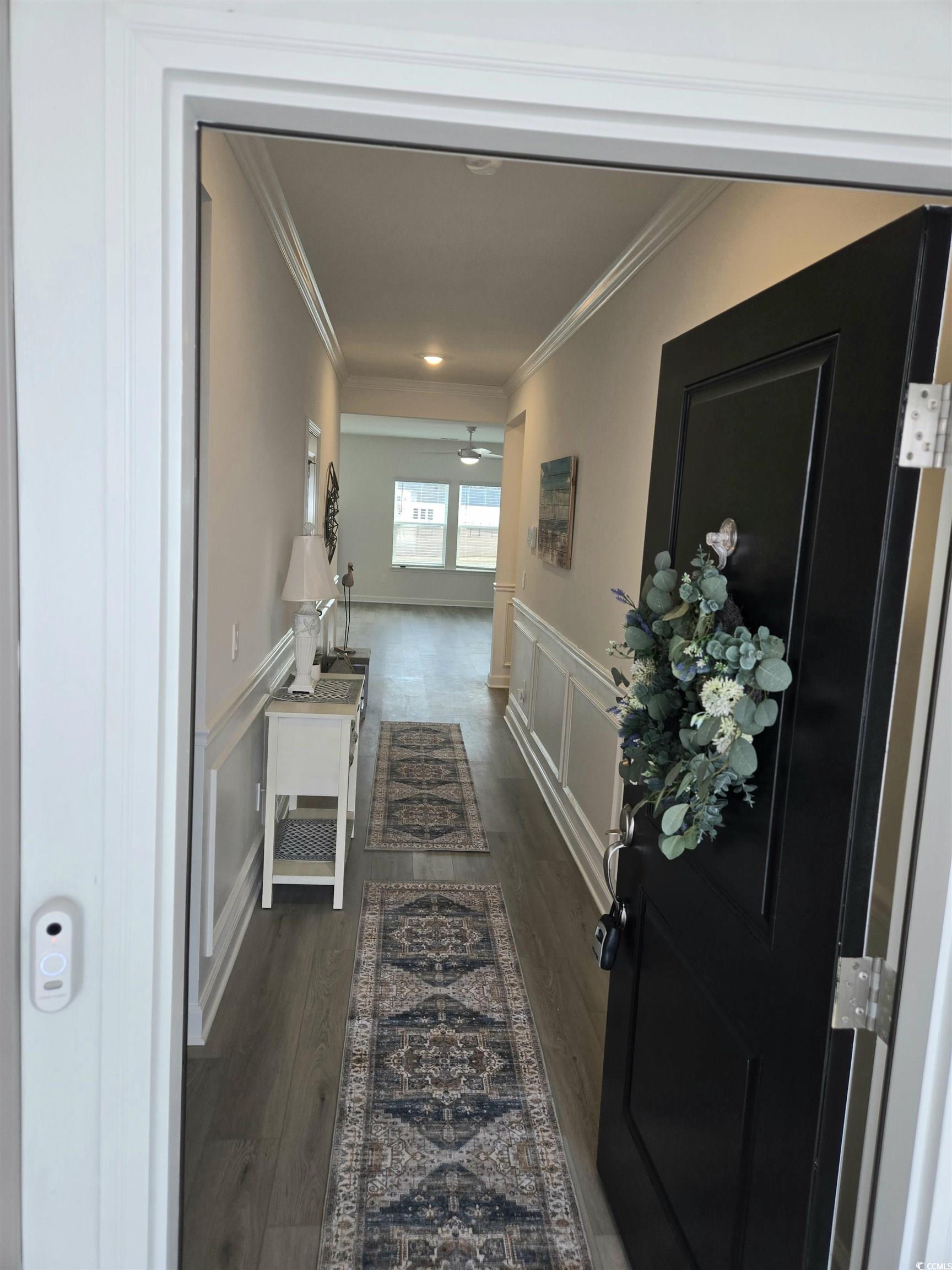 1546 Regal Fern Way Longs, SC 29568 - Photo 3 of 34 Hall featuring wainscoting, a decorative wall, dark wood-style floors, and ornamental molding