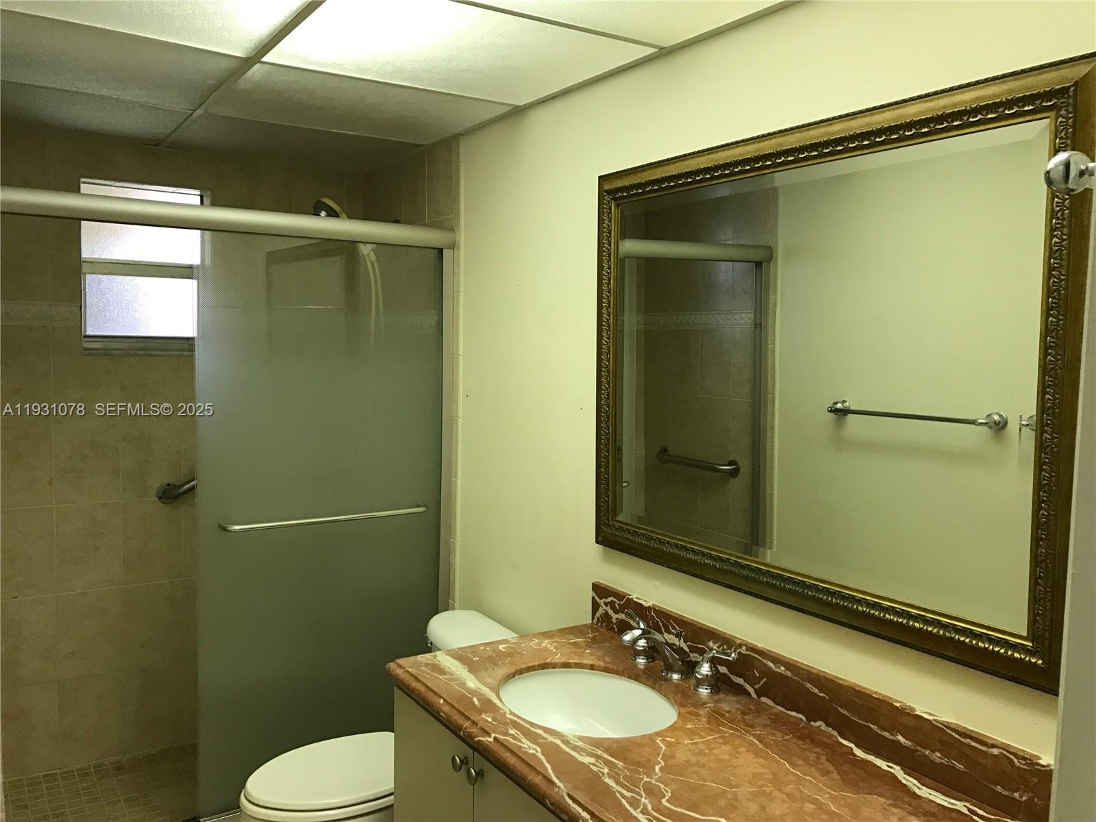 100 Northwest 87th Avenue, Unit E102 Miami, FL 33172 - Photo 14 of 17 a bathroom with a sink and mirror