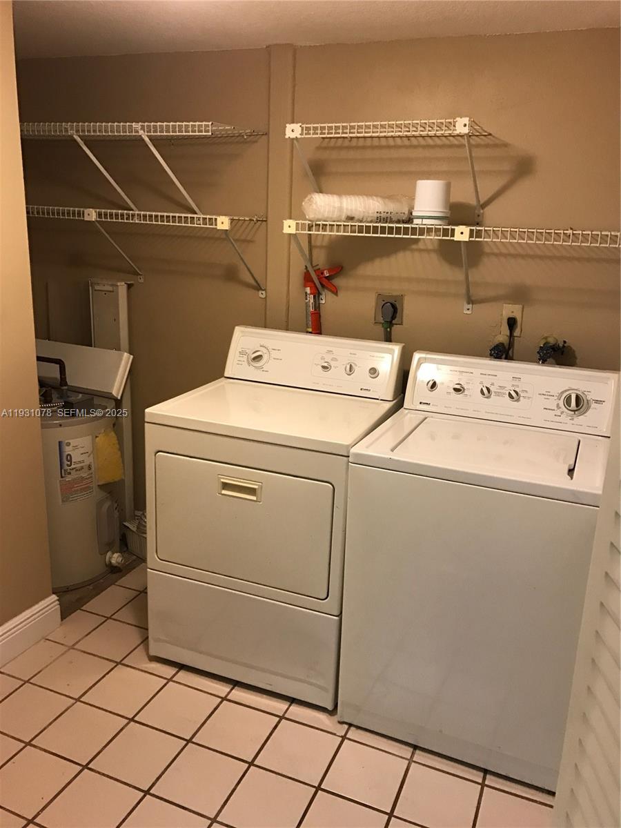 100 Northwest 87th Avenue, Unit E102 Miami, FL 33172 - Photo 16 of 17 a utility room with dryer and washer
