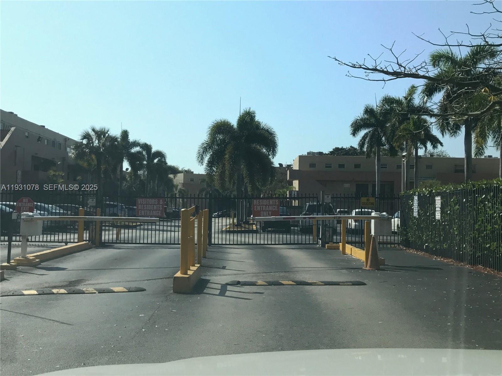 100 Northwest 87th Avenue, Unit E102 Miami, FL 33172 - Photo 2 of 17 a view of a swimming pool with a table and chairs