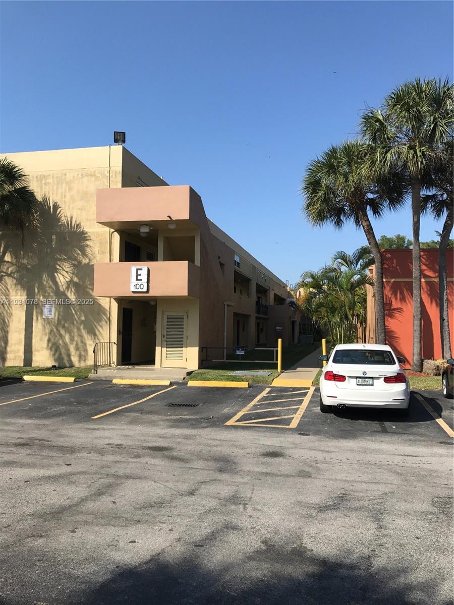 100 Northwest 87th Avenue, Unit E102 Miami, FL 33172 - Photo 3 of 17 a view of street with parked cars