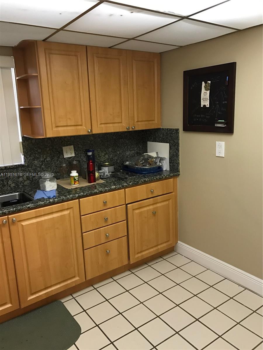 100 Northwest 87th Avenue, Unit E102 Miami, FL 33172 - Photo 8 of 17 a kitchen with stainless steel appliances granite countertop a refrigerator sink and cabinets