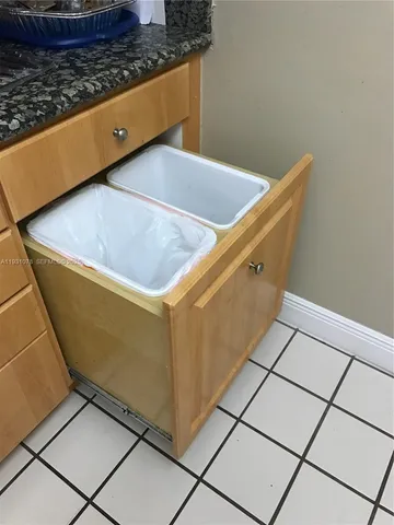 a bathroom with a granite countertop toilet sink and mirror