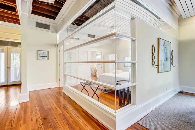 a view of a room with wooden floor and white walls