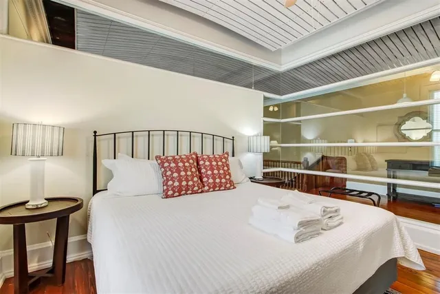 a bedroom with a bed and a large window